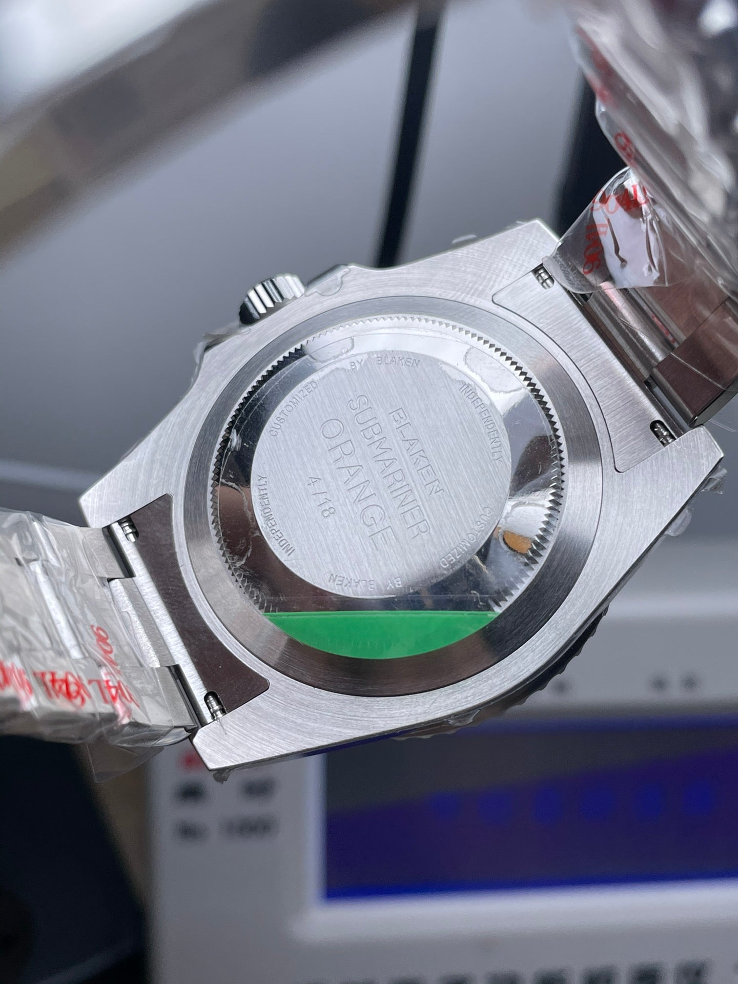 Rolex Submariner watch with an orange dial and bezel