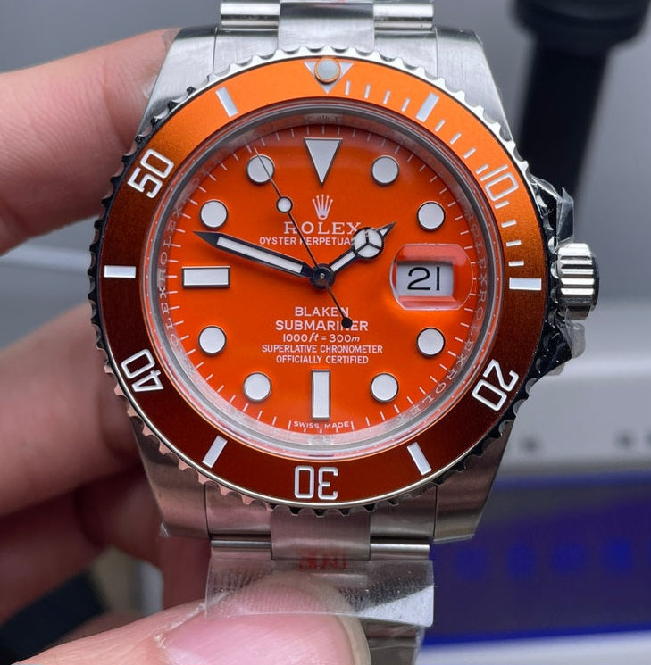 Rolex Submariner watch with an orange dial and bezel