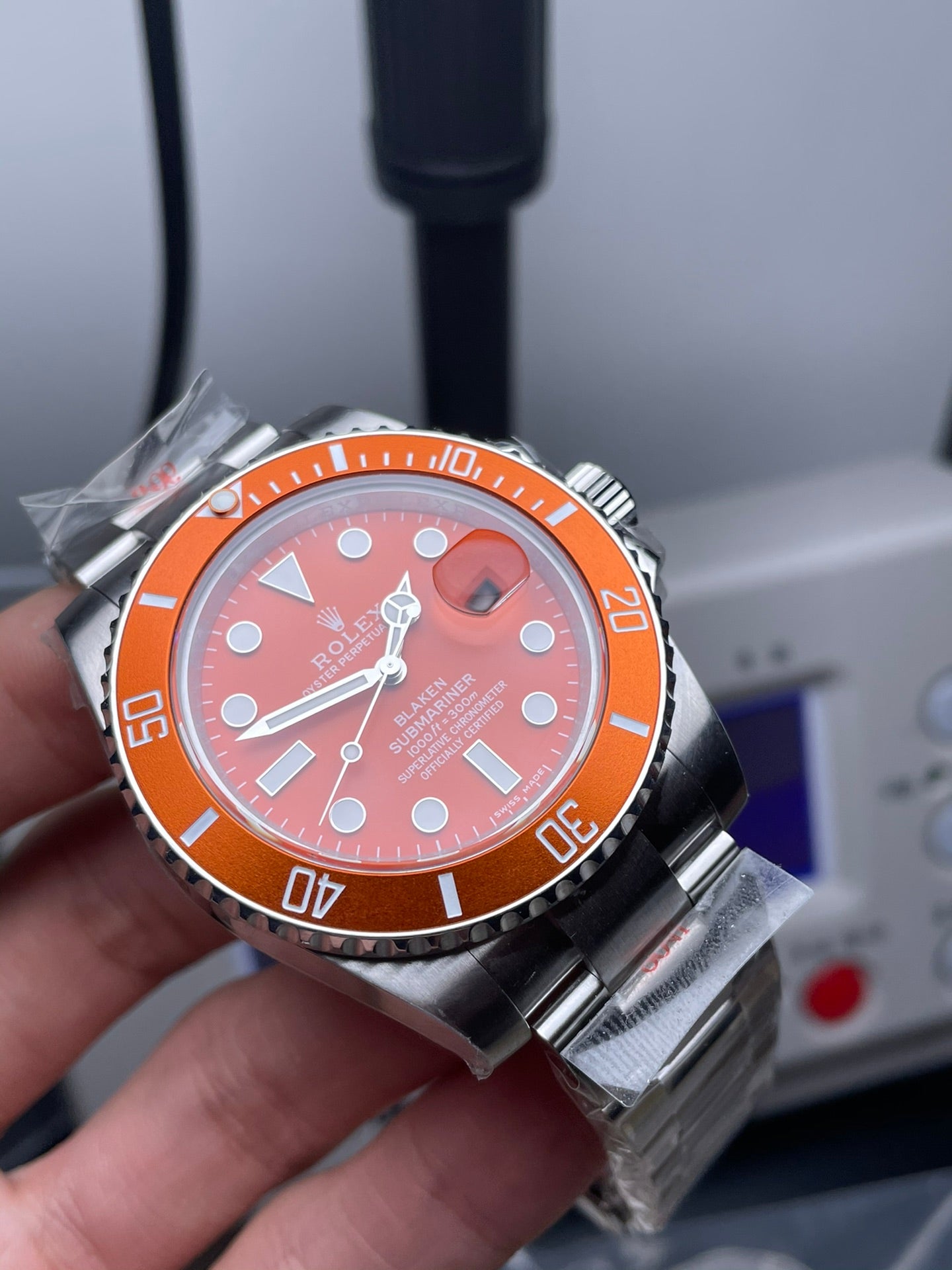 Rolex Submariner watch with an orange dial and bezel