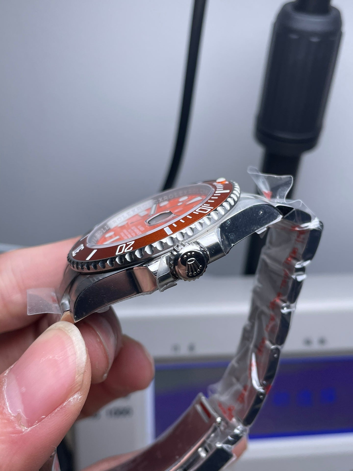 Rolex Submariner watch with an orange dial and bezel