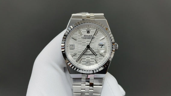 Rolex Land-Dweller watch with a silver dial and fluted bezel