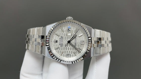 Rolex Land-Dweller watch with a silver dial and fluted bezel