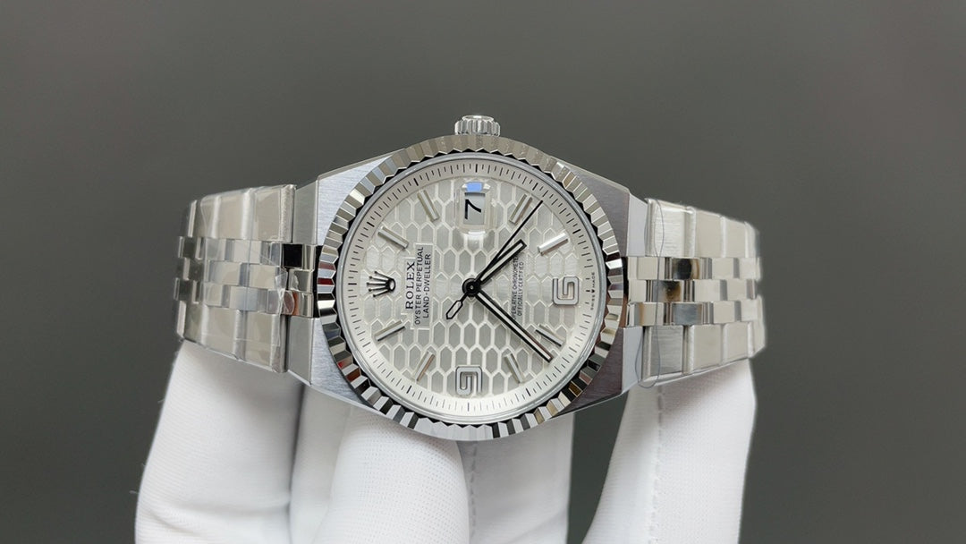 Rolex Land-Dweller watch with a silver dial and fluted bezel